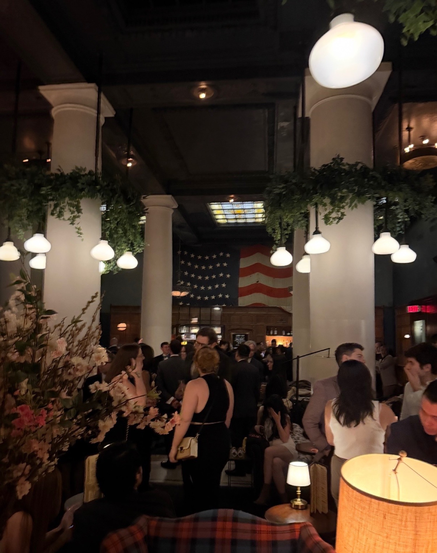 Guests at the Birthday Charity Gala, under the flag.